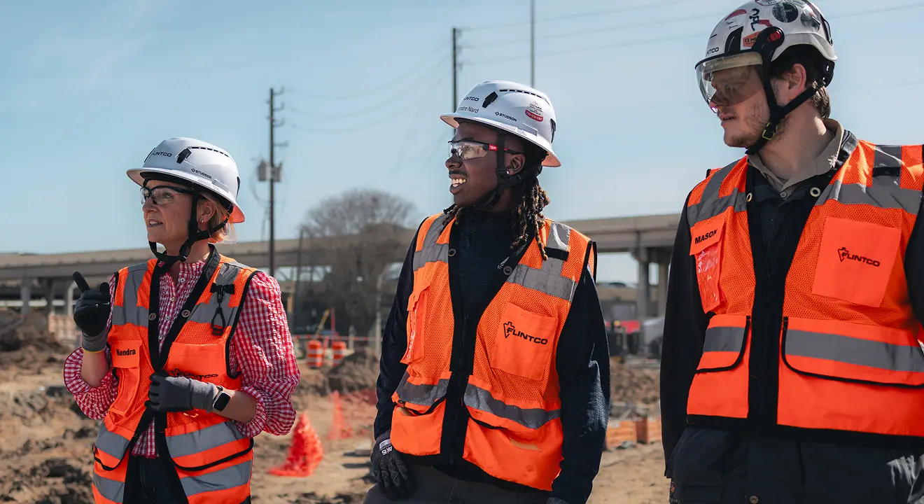 Workers in orange vests