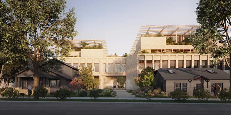 Modern building complex with large windows and rooftop gardens flanked by smaller, cozy houses. Tall trees and a clear sky create a calm, harmonious scene.