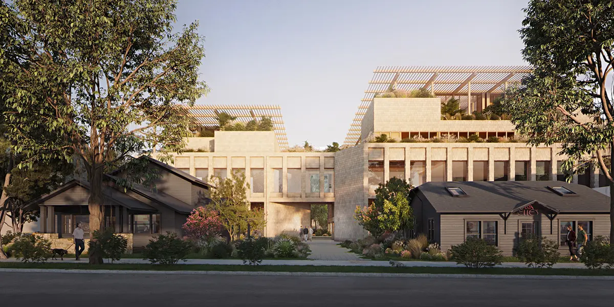 Modern building complex with large windows and rooftop gardens flanked by smaller, cozy houses. Tall trees and a clear sky create a calm, harmonious scene.